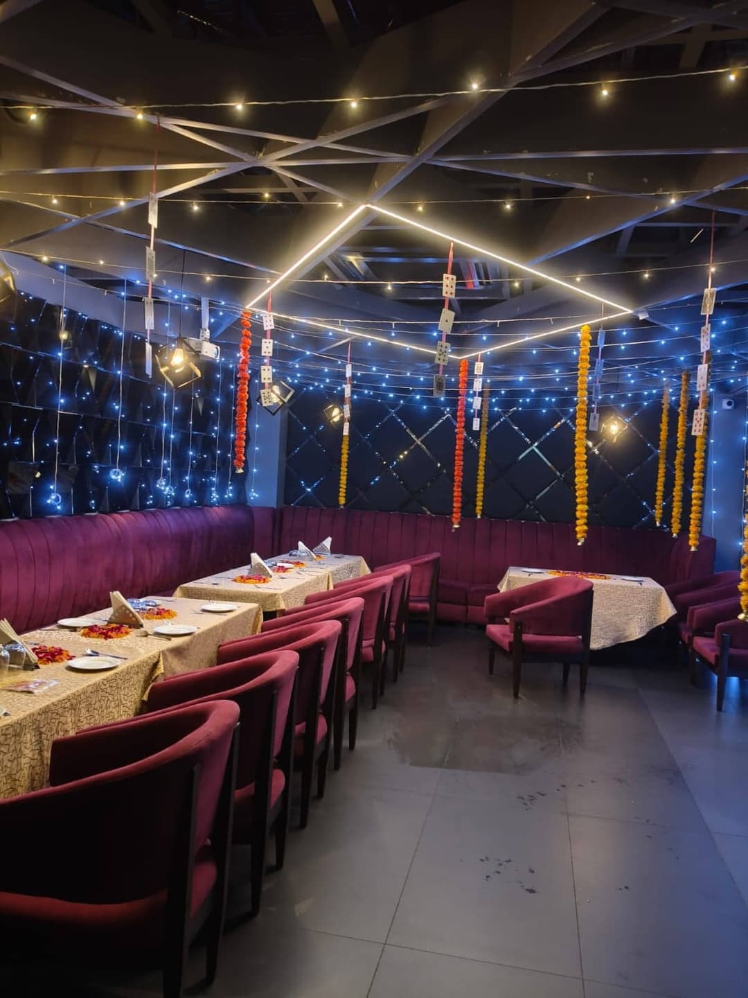 The private dining hall, with draped ceiling fabric above velvet-seated tables